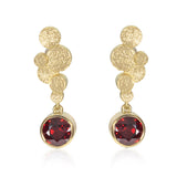 Staffa earrings are formed of undulating discs of 18ct gold with dreamy deep red spessarite garnet drops.  Staffa spessarite garnet earrings by Sarah Herriot.