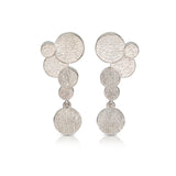 Staffa earrings are formed of undulating discs of silver with a deep textured surface. Staffa earrings by Sarah Herriot.