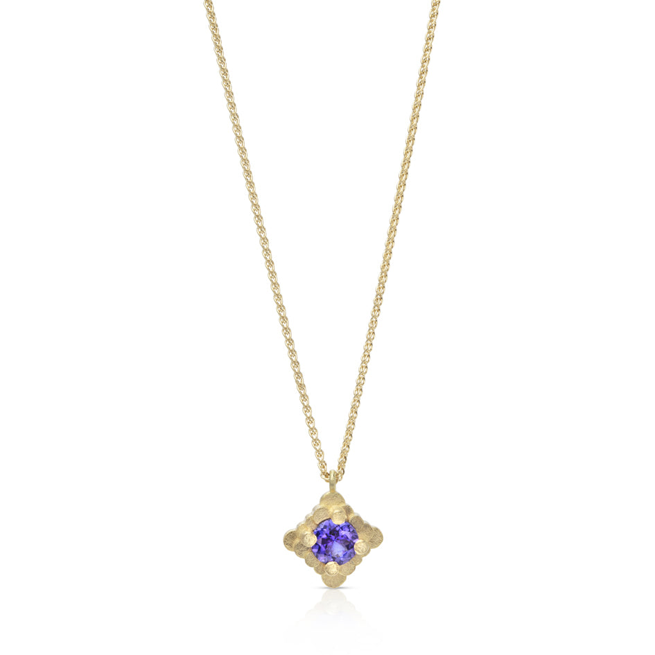 Staffa necklace is formed of undulating columns of 18ct gold with a gorgeous tanzanite nestled within. The design is inspired by Fingal's cave on the Isle of Staffa off the west coast of Scotland. Textured surfaces echo the natural basalt rock formations. Staffa necklace by Sarah Herriot.