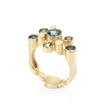 Staffa ring formed of undulating columns of 18ct gold set with five sea coloured australian sapphires. The design is inspired by fingal's cave on the isle of staffa off the west coast of scotland and the sapphires selected to echo that landscape. Staffa ring by Sarah Herriot.
