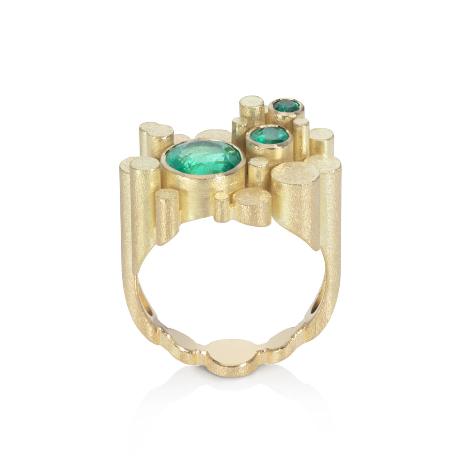 Staffa ring formed of undulating columns of 18ct gold and three gorgeous emeralds nestled within.  Staffa ring by Sarah Herriot.