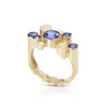 Staffa ring formed of undulating columns of 18ct gold and five vibrant blue Sri Lankan sapphires. The design is inspired by Fingal's cave on the Isle of Staffa off the west coast of Scotland. Textured surfaces echo the natural basalt rock formations. Staffa ring by Sarah Herriot.
