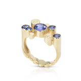 Staffa ring formed of undulating columns of 18ct gold and five vibrant blue Sri Lankan sapphires. The design is inspired by Fingal's cave on the Isle of Staffa off the west coast of Scotland. Textured surfaces echo the natural basalt rock formations. Staffa ring by Sarah Herriot.