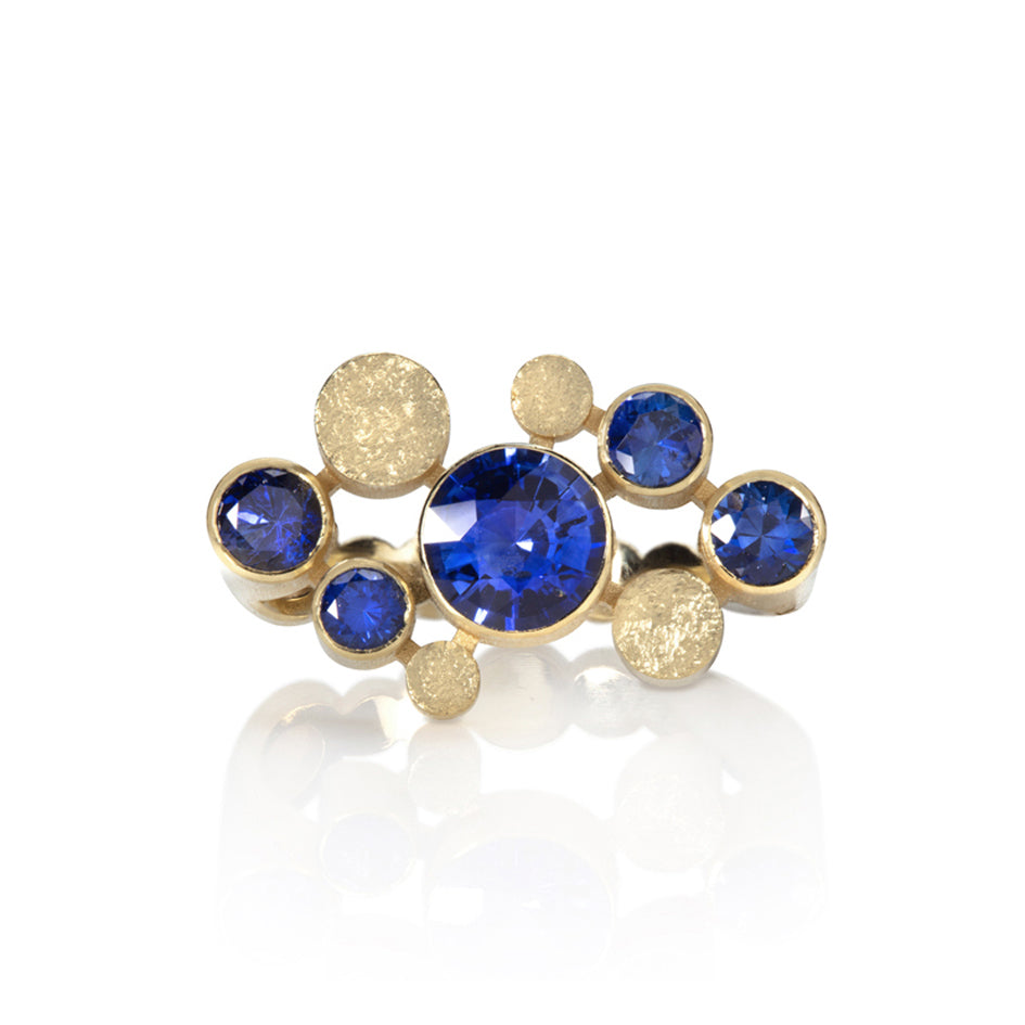 Staffa ring formed of undulating columns of 18ct gold and five vibrant blue Sri Lankan sapphires. The design is inspired by Fingal's cave on the Isle of Staffa off the west coast of Scotland. Textured surfaces echo the natural basalt rock formations. Staffa ring by Sarah Herriot.