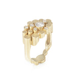 Staffa ring formed of undulating columns of 18ct gold and a scattering of seven vibrant blue Sri Lankan sapphires. The design is inspired by fingal's cave on the isle of staffa off the west coast of Scotland. Textured surfaces echo the natural basalt rock formations. Staffa reing by Sarah Herriot.