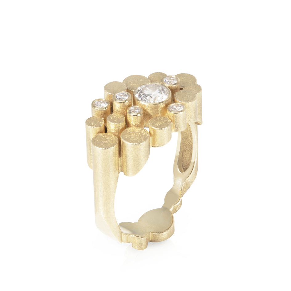 Staffa ring formed of undulating columns of 18ct gold and a scattering of seven vibrant blue Sri Lankan sapphires. The design is inspired by fingal's cave on the isle of staffa off the west coast of Scotland. Textured surfaces echo the natural basalt rock formations. Staffa reing by Sarah Herriot.