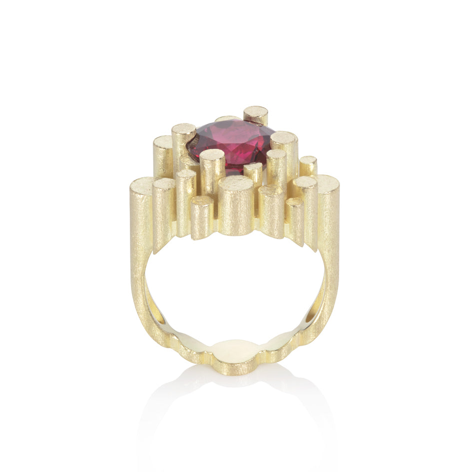 Staffa ring formed of undulating columns of 18ct gold and a stunning deep red rubellite tourmaline nestled within.  Staffa ring by Sarah Herriot.
