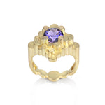 Staffa ring formed of undulating columns of 18ct gold and a gorgeous tanzanite nestled within.  Staffa ring by Sarah Herriot.