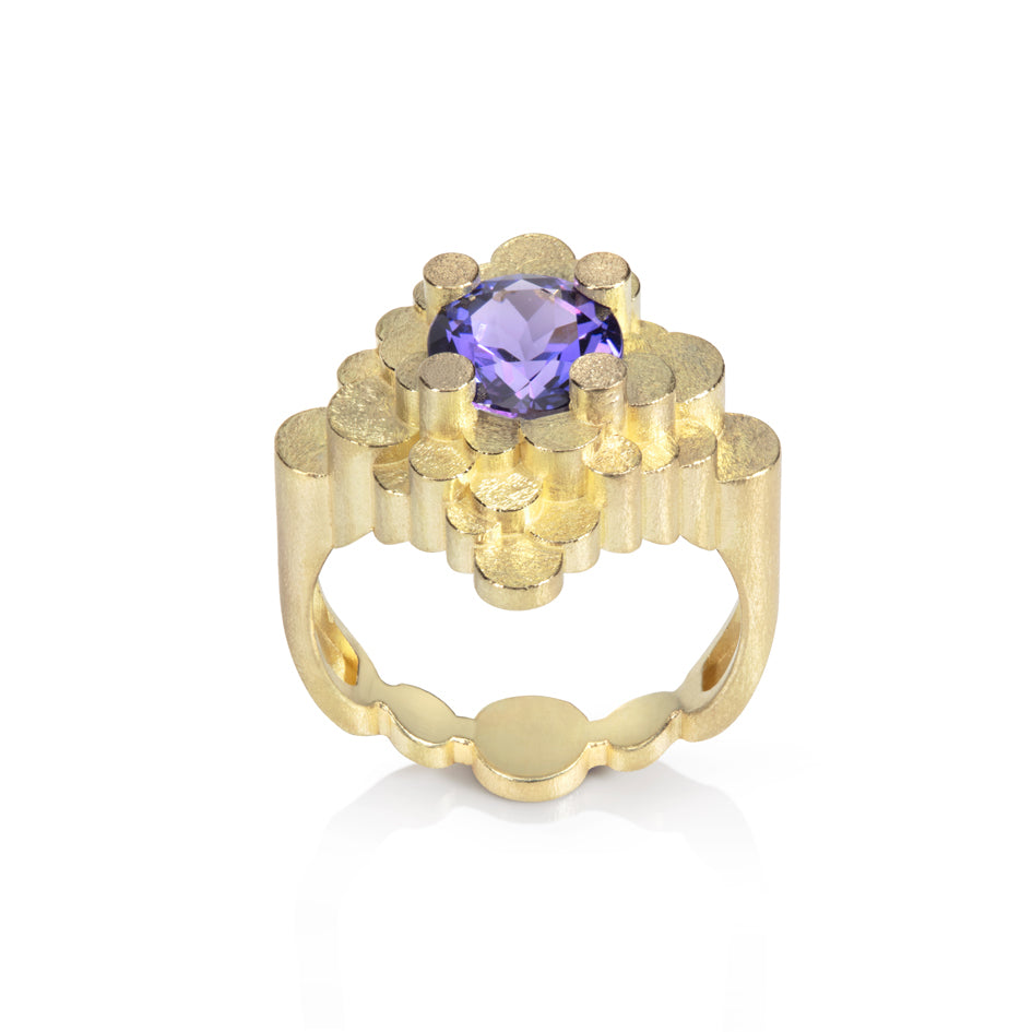 Staffa ring formed of undulating columns of 18ct gold and a gorgeous tanzanite nestled within.  Staffa ring by Sarah Herriot.
