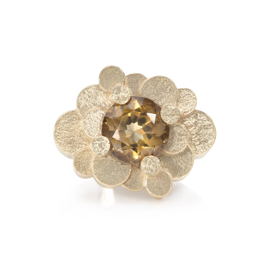 Staffa ring formed of undulating columns of 9ct gold and a golden tourmaline nestled within.  Staffa ring by Sarah Herriot.