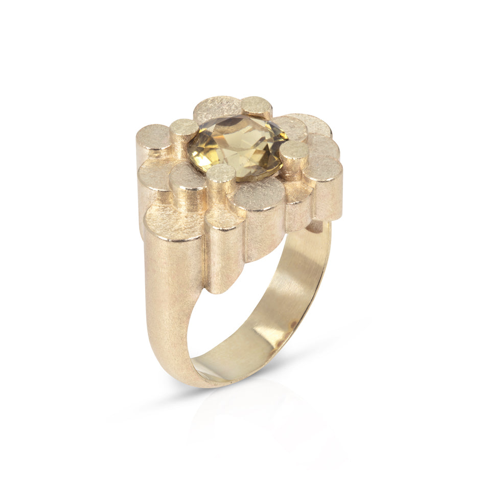 Staffa ring formed of undulating columns of 9ct gold and a golden tourmaline nestled within.  Staffa ring by Sarah Herriot.