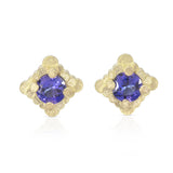 Staffa earrings formed of undulating columns of 18ct gold with a gorgeous tanzanites nestled within. The design is inspired by Fingal's cave on the Isle of Staffa off the west coast of Scotland. Textured surfaces echo the natural basalt rock formations. Staffa stud earrings by Sarah Herriot.