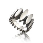 Stepping stone ring in silver is a path of silver steps around the finger, with oxidised recesses to accentuate the sculptural nature of the piece. Stepping stone ring by Sarah Herriot.