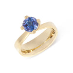 Elegant twisted collet rises to hold a vibrant blue tanzanite in this 18ct gold Twist and Taper ring. Twist and Taper ring by Sarah Herriot.