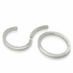 A masterfully engineered solid silver bangle with a seamless tension clasp that requires no visible mechanism. The square-section wire creates a refined, sculptural form that sits beautifully on the wrist with an authentic weight and presence. Seamless design embodies minimalist principles, pure form without ornamentation.  Tension bangle by Sarah Herriot.