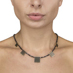 Black diamond cube neckpiece with linear 18ct gold pieces by Sarah Herriot.