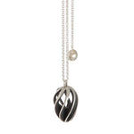 Twist and shout pendant is a wonderfully rythmic form in silver, constructed using open work twisted sheets of silver and oxidised or textured recesses to accentuate the sculptural nature of the piece.  Twist and shout pendant by Sarah Herriot.
