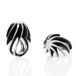 Twist and shout ring is a wonderfully architecturally formed ring in silver, twisted and flowing sheets of silver with oxidised recesses to accentuate the sculptural nature of the piece.  Twist and shout ring by Sarah Herriot.