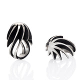 Twist and shout ring is a wonderfully architecturally formed ring in silver, twisted and flowing sheets of silver with oxidised recesses to accentuate the sculptural nature of the piece.  Twist and shout ring by Sarah Herriot.