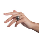 Twist and shout ring is a wonderfully architecturally formed ring in silver, twisted and flowing sheets of silver with oxidised recesses to accentuate the sculptural nature of the piece.  Twist and shout ring by Sarah Herriot.