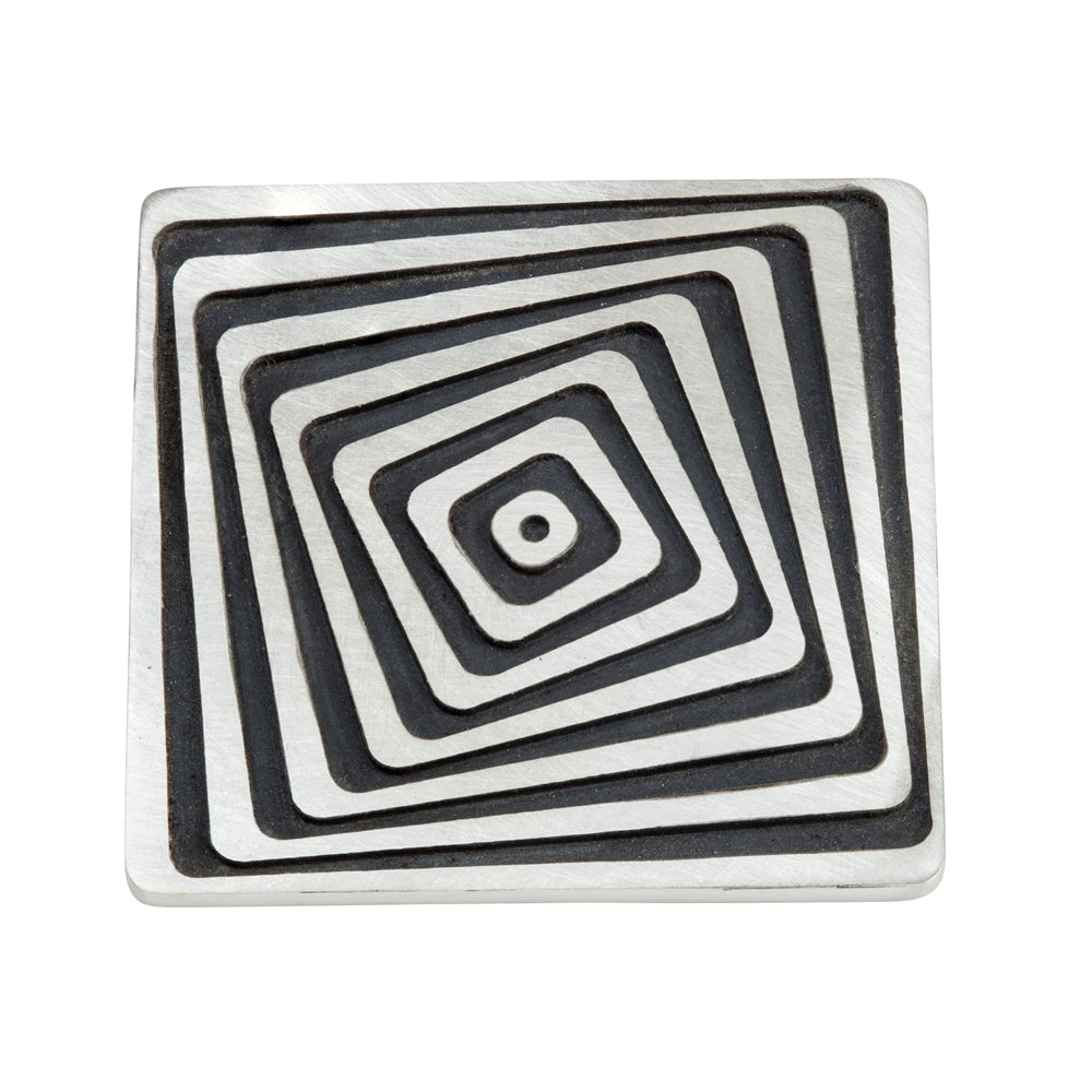 Vertigo brooch in silver with oxidised recesses by Sarah Herriot.