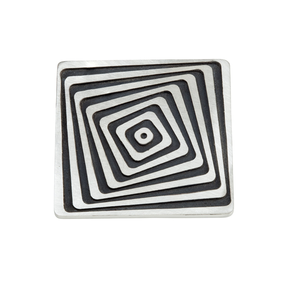 Vertigo brooch in silver, comprised of an offset linear construction, blackened recesses accentuate the design. Vertigo brooch by Sarah Herriot.